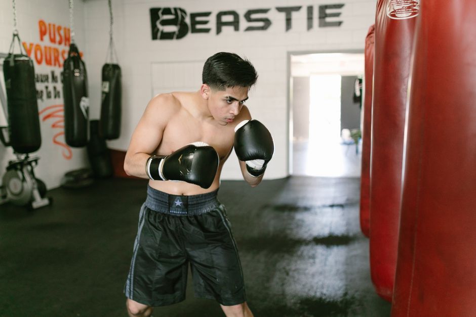 Boxer in fighting stance with gloves up at chin level, body exposed as a target for hooks