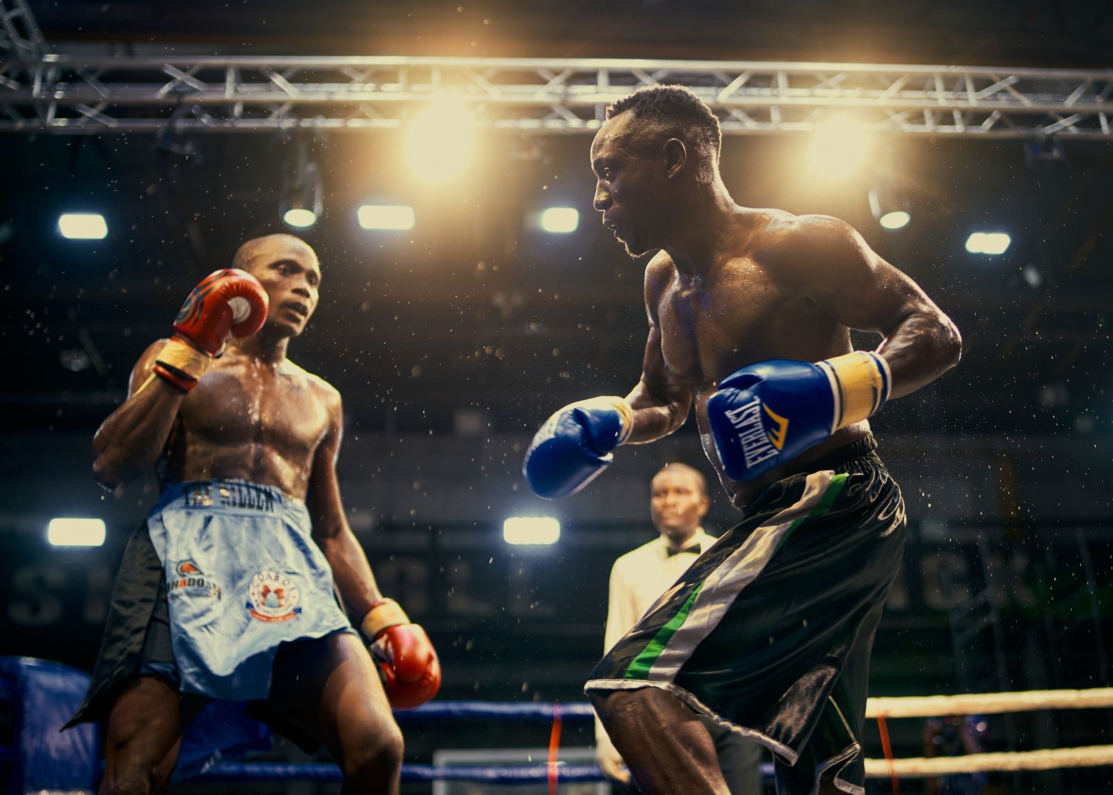 Two boxers in mid-action during a fight in an arena, illustrating the kind of striking exchange Gaethje thrives in