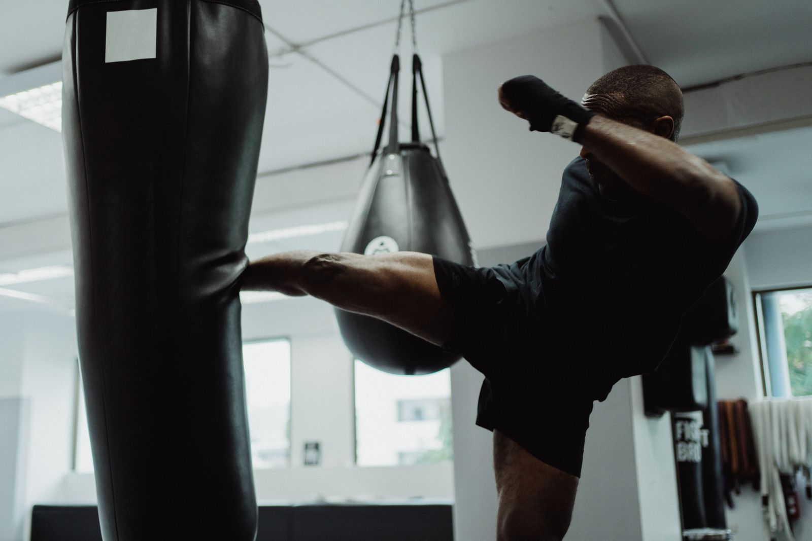 Fighter landing a high kick during striking training