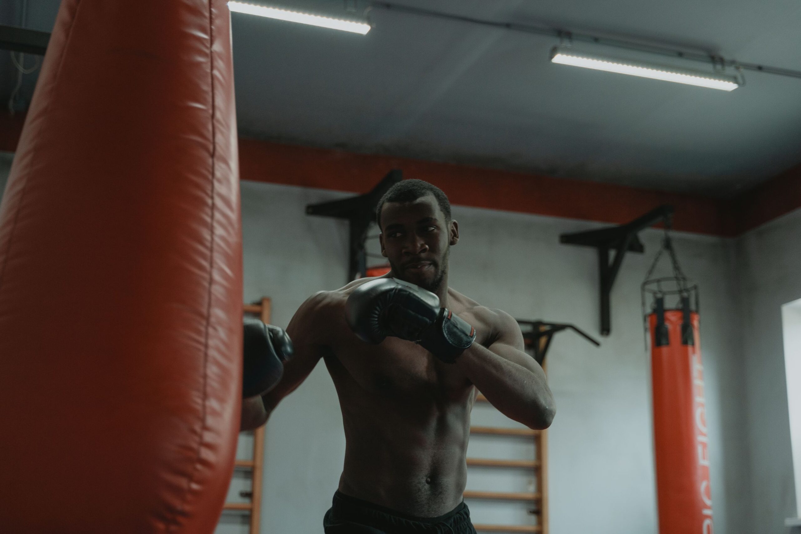 MMA fighter performing heavy bag training as part of a sport-specific conditioning session