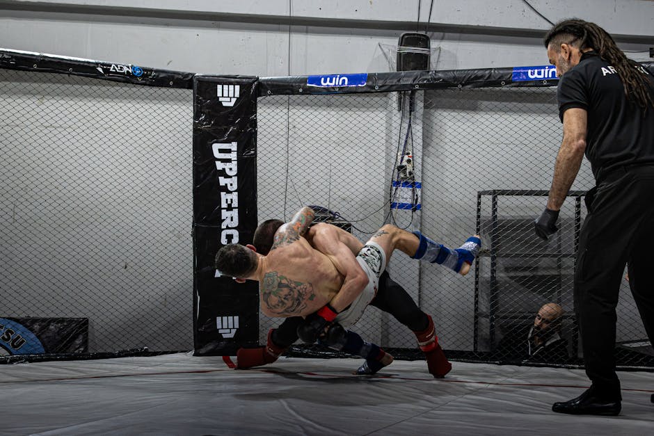 MMA fighter executing a cage-press takedown against an opponent