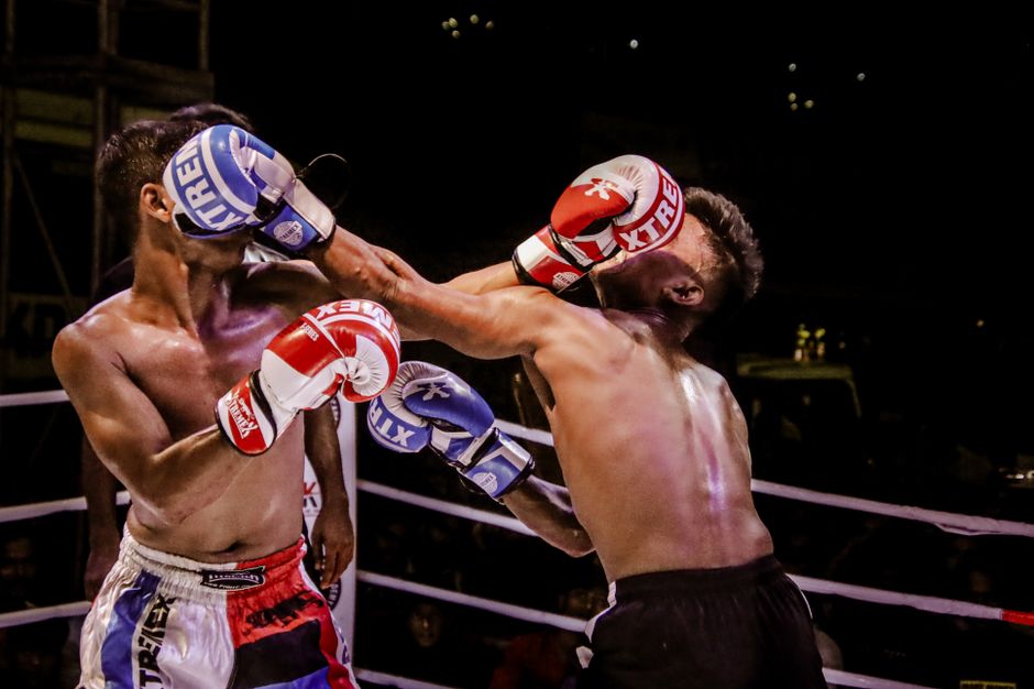 Two fighters trading punches in a ring, illustrating the striking exchanges that define a Sean O'Malley fight