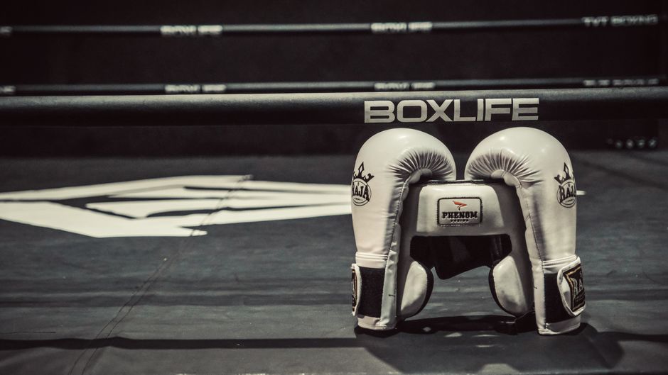 Boxing gloves resting on the ropes of a ring, symbolizing the decision over O'Malley's next opponent