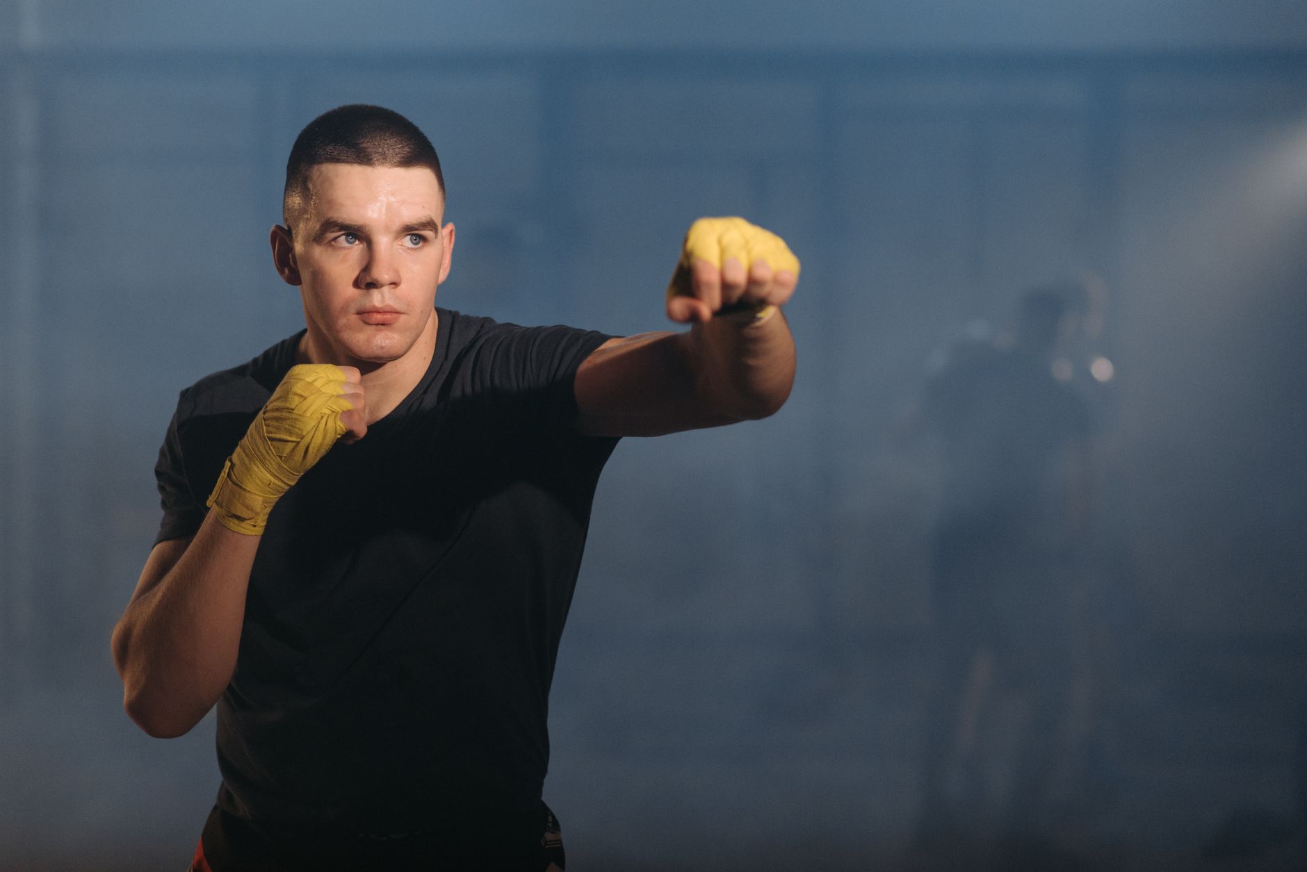 Fighter throwing a straight rear hand down the middle in an open stance