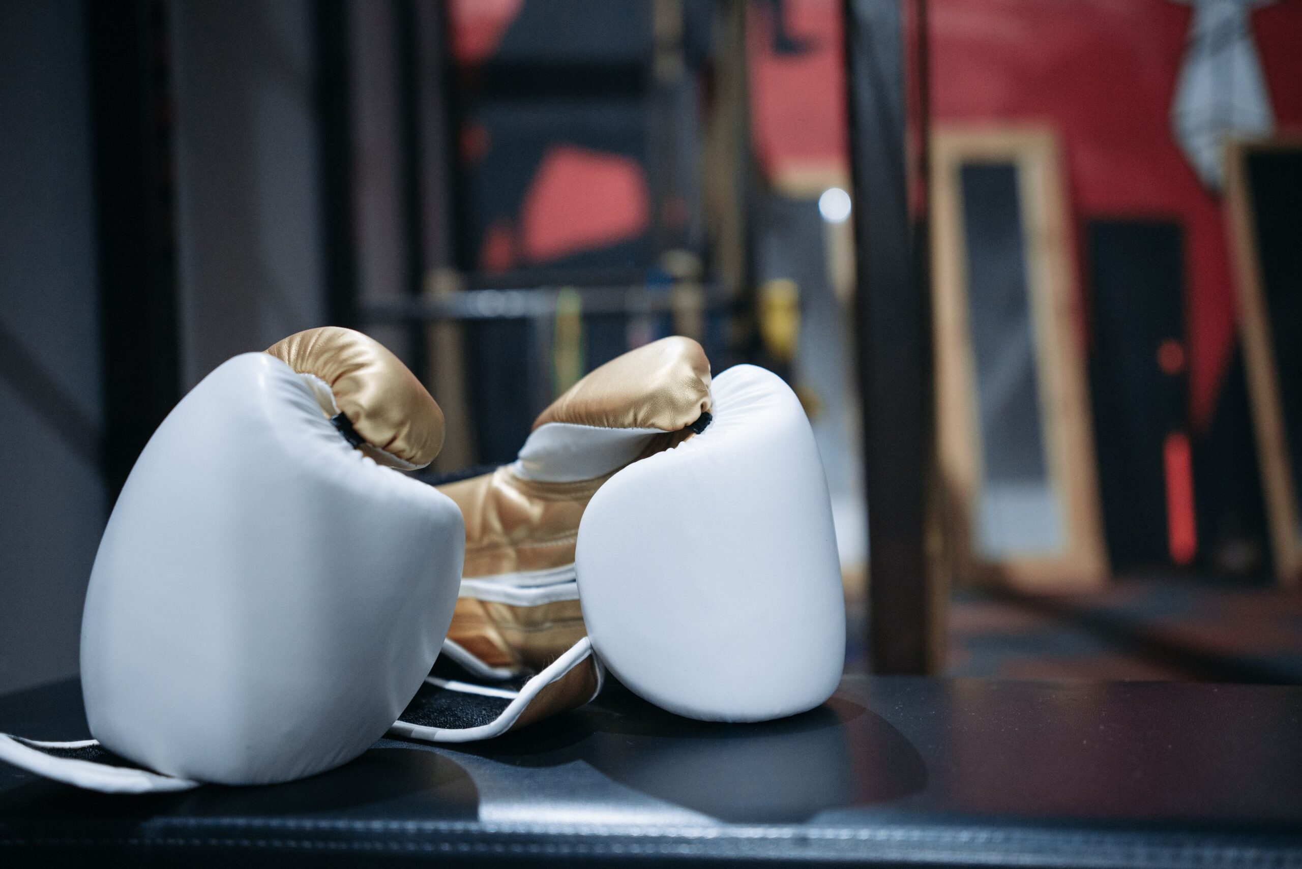 Boxing gloves on display, symbolizing the precision-versus-volume striking matchup