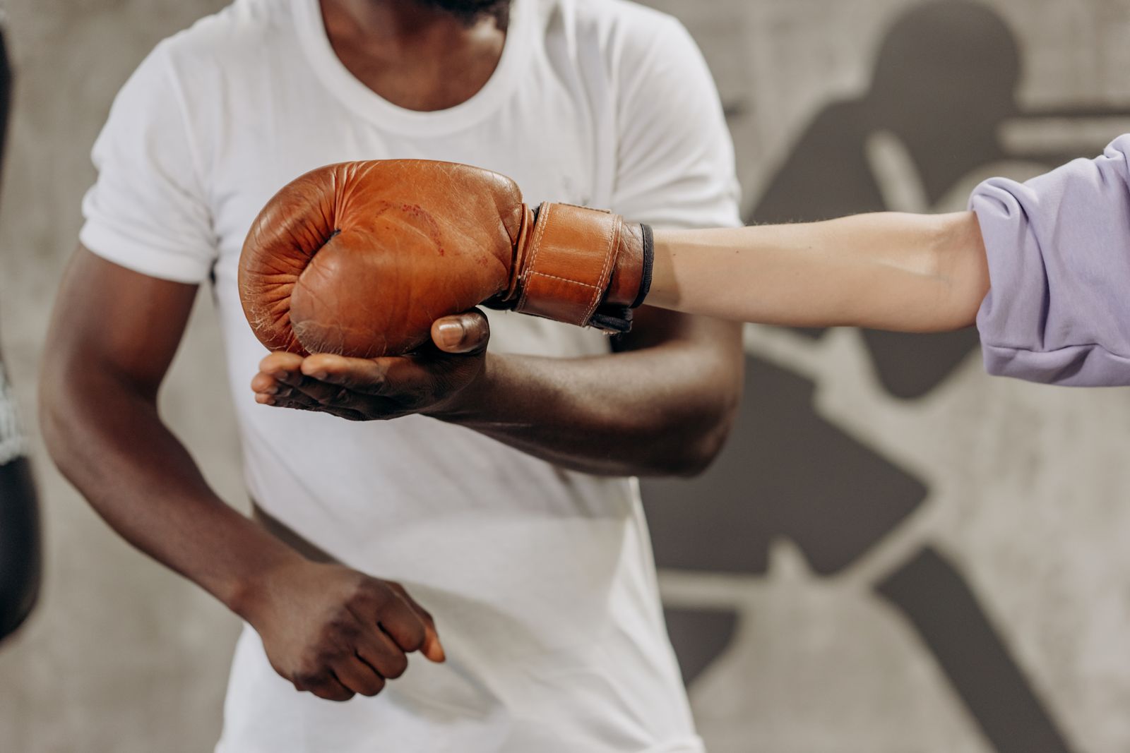 Boxing glove being inspected by trainer before fight