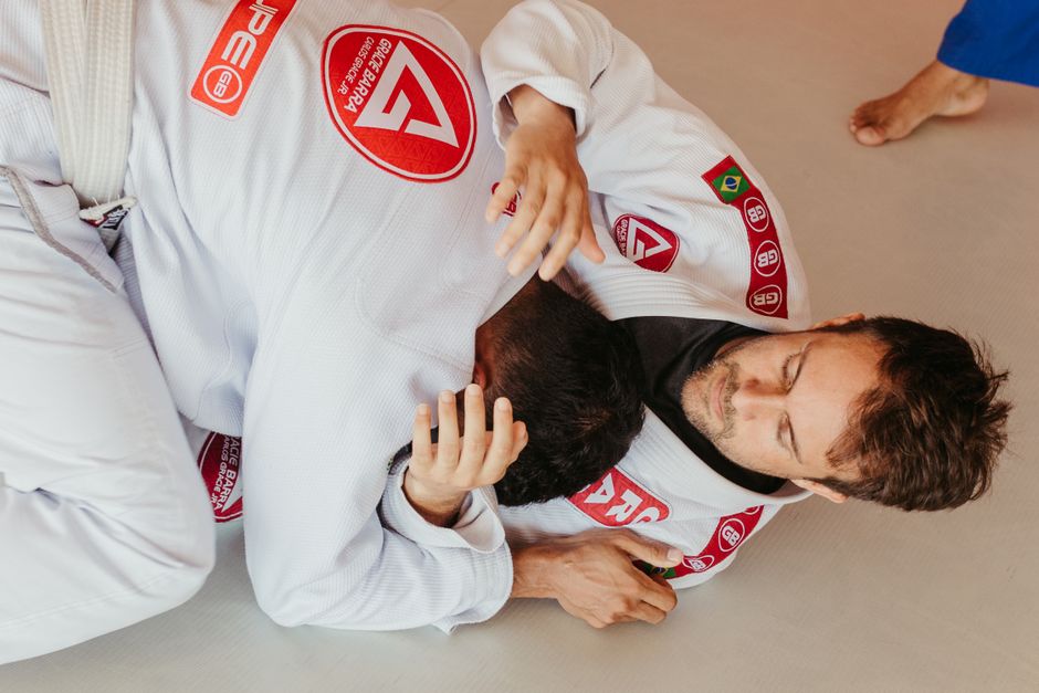 Two grapplers in a tight head-and-arm control position on the mat