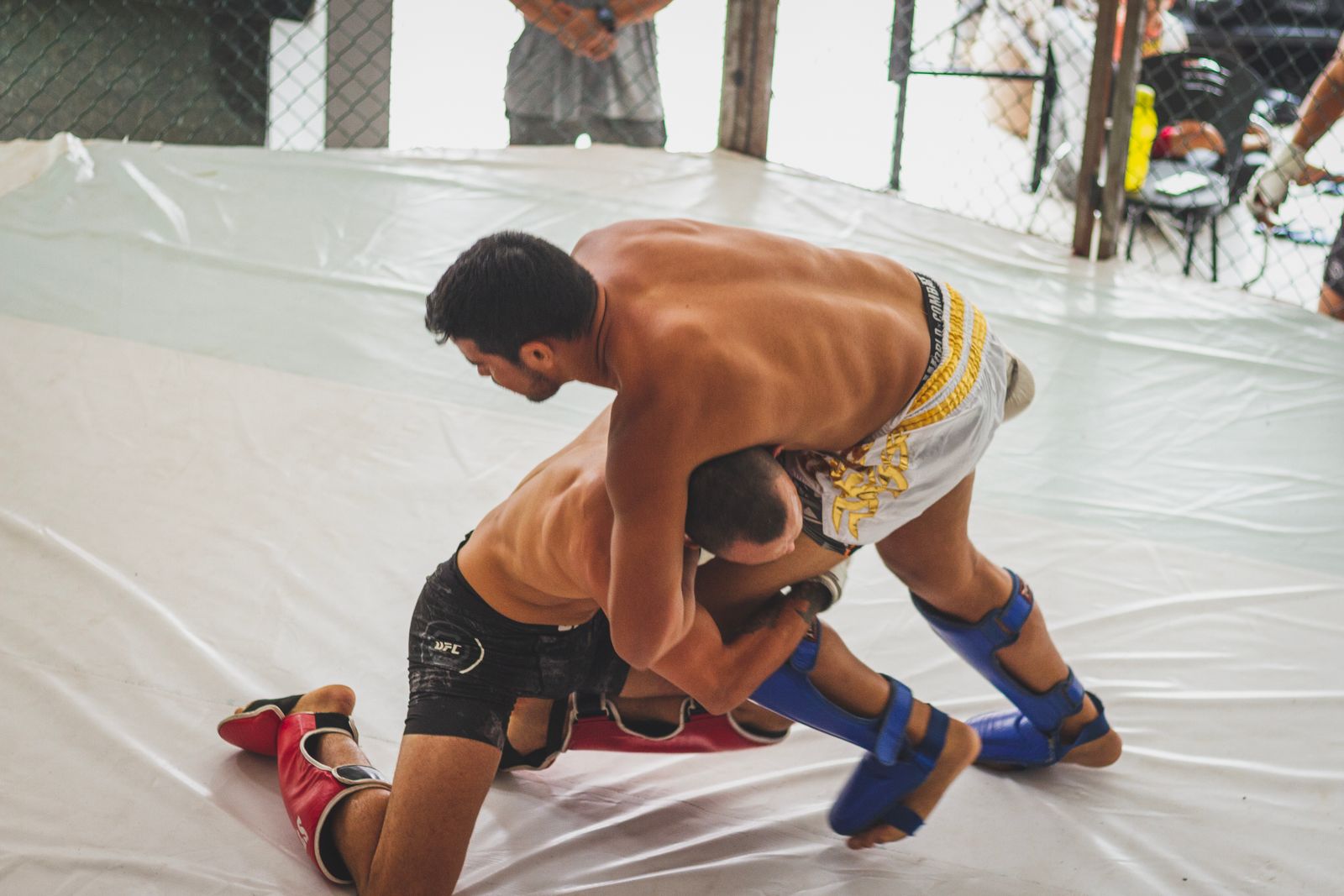 MMA fighter changing levels and shooting a double leg takedown