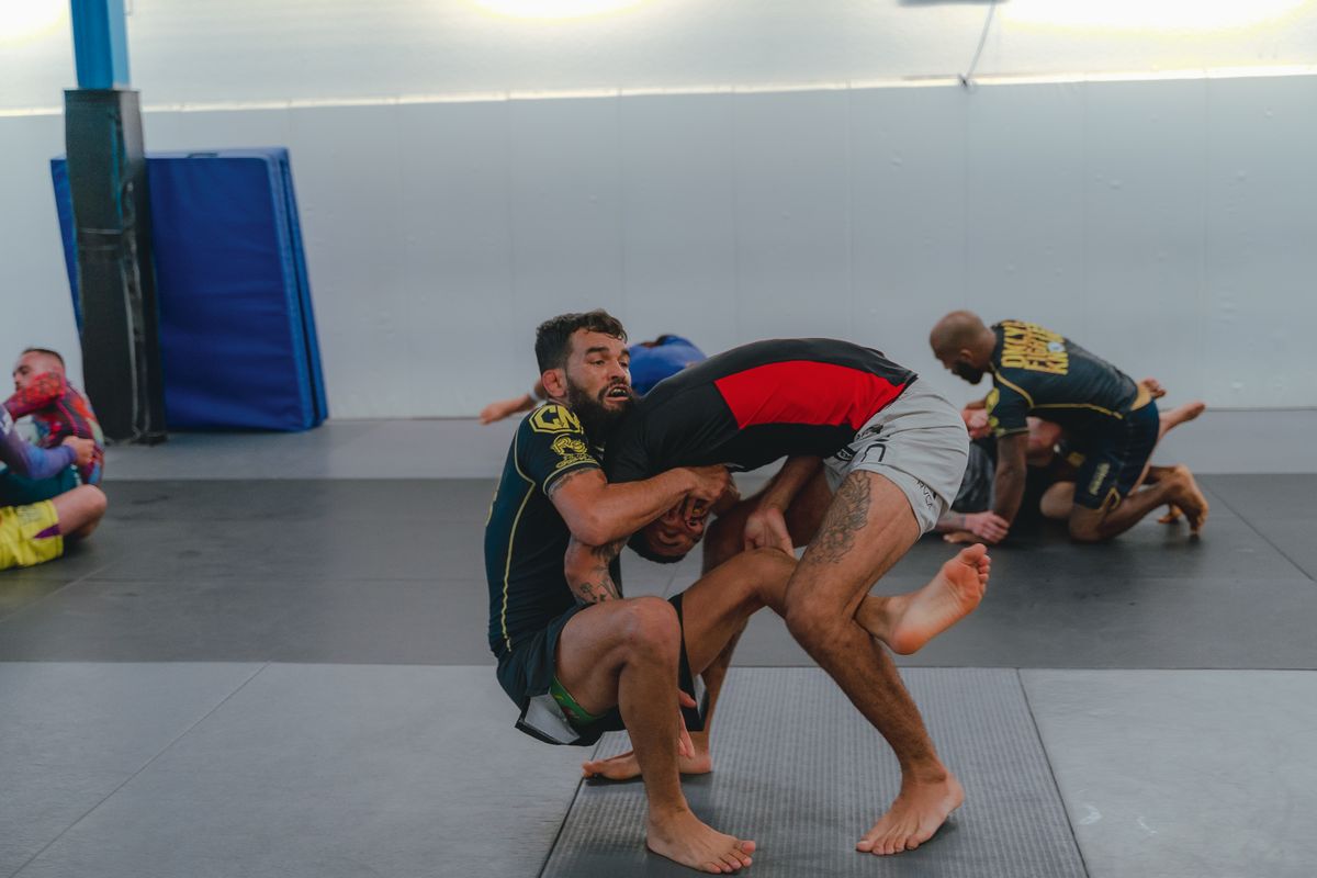 MMA fighters training wrestling and grappling techniques