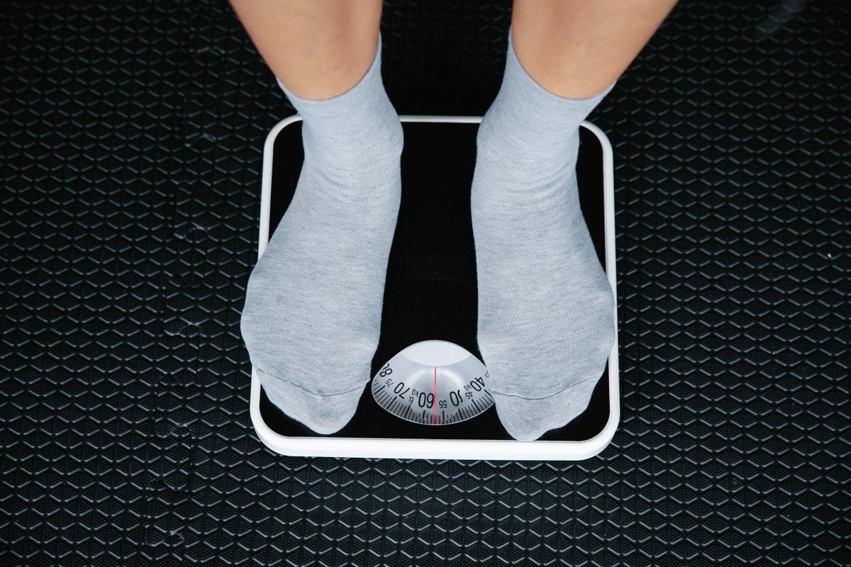 Feet on a bathroom scale representing a fighter making weight
