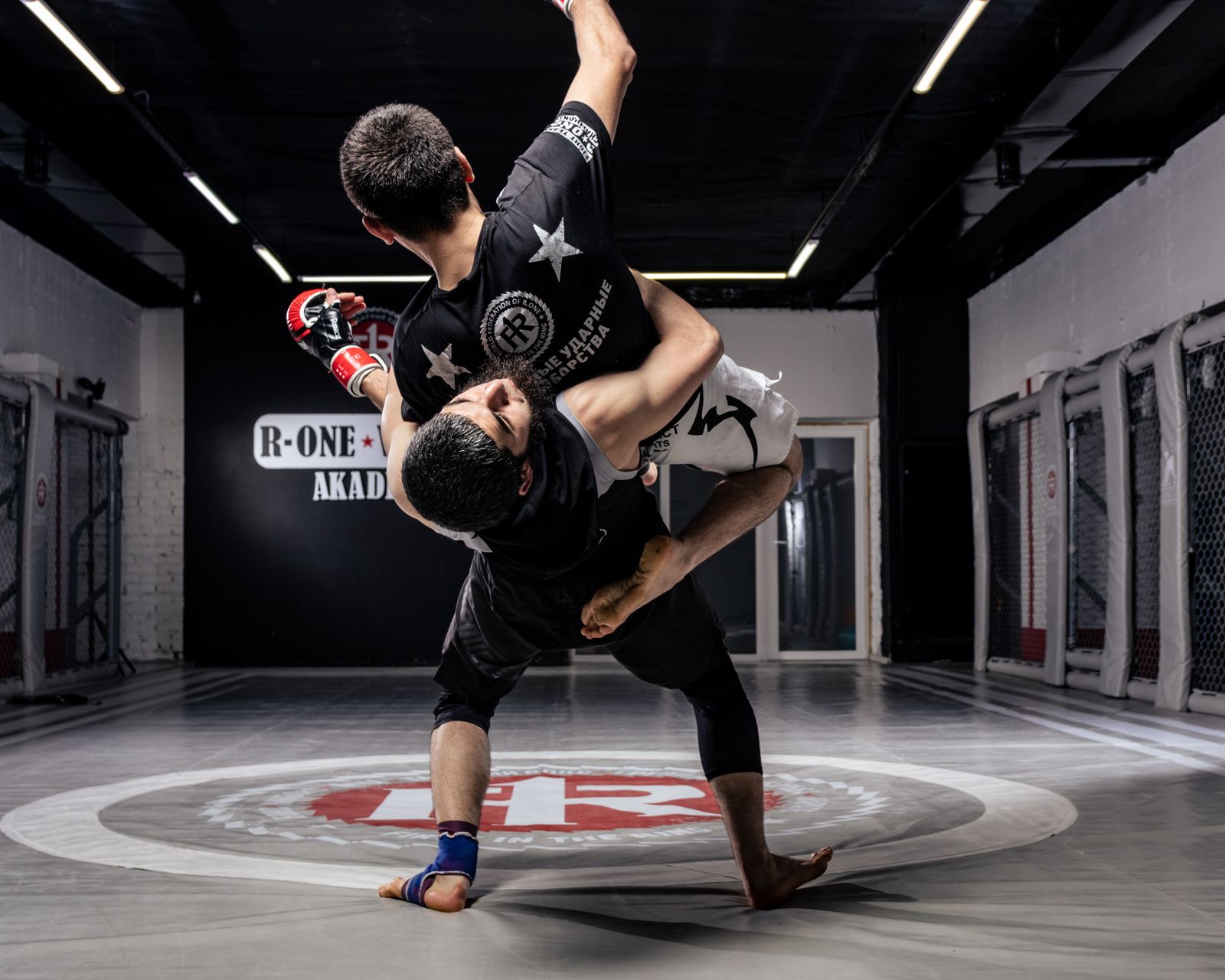 MMA fighter completing a slam takedown in training