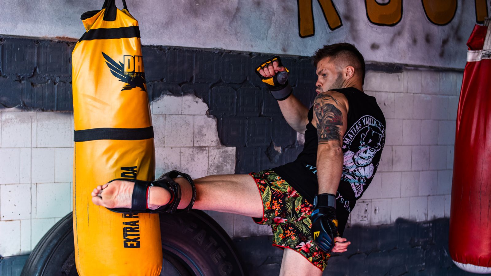 Fighter drilling kicks on a heavy bag, building the output volume striking requires