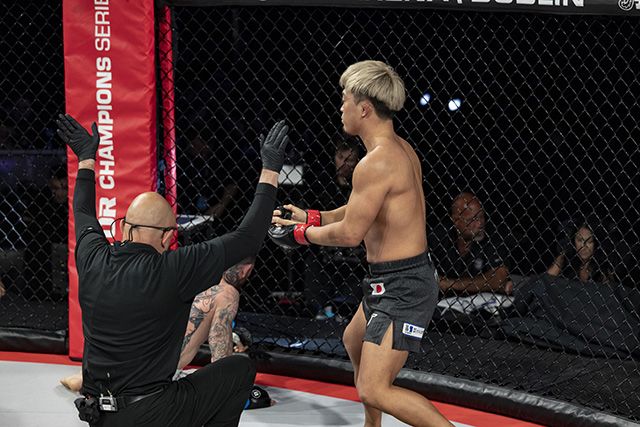 Shinobu Ota has his hand raised after a north-south choke submission win at Bellator Dublin