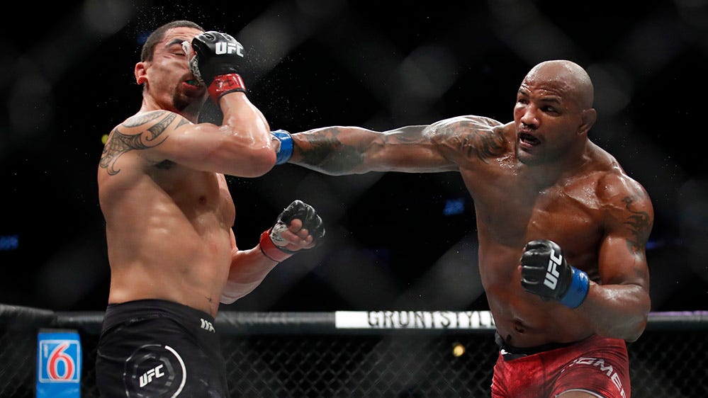 Robert Whittaker and Yoel Romero trade punches during their split-decision fight at UFC 225