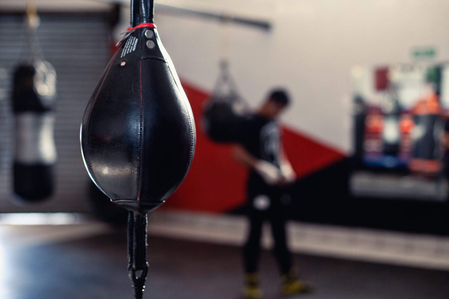 fighter hitting heavy bag in gym training session