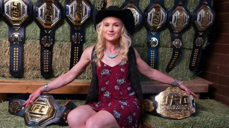 Valentina Shevchenko poses with multiple UFC flyweight championship belts from her career