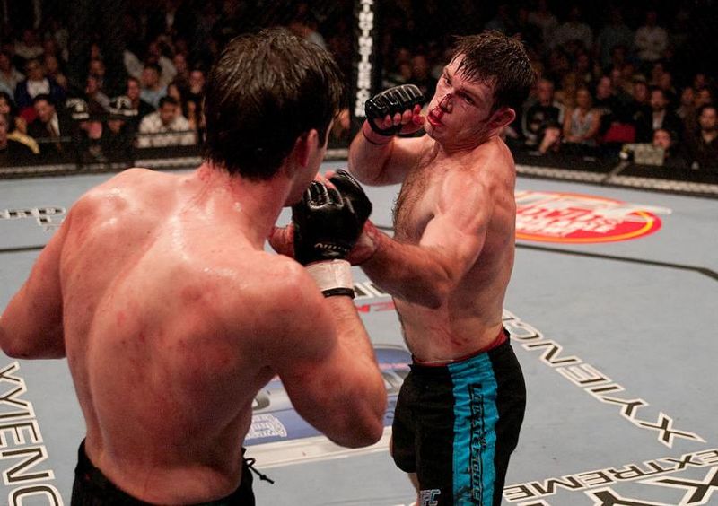 A bloodied Stephan Bonnar exchanges punches with Forrest Griffin in round three