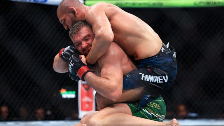 Khamzat Chimaev controlling Dricus du Plessis during a guard passing sequence at UFC 319