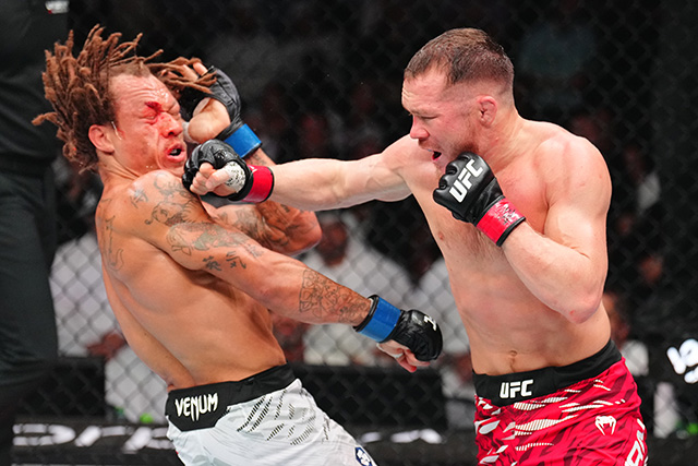 Petr Yan lands a right hand in the UFC octagon as UFC bantamweight champion