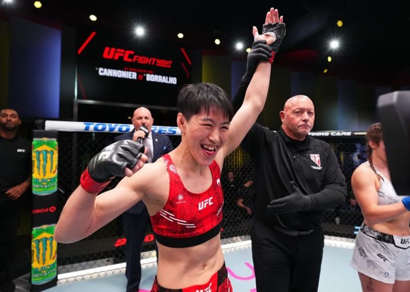 Wang Cong celebrates after a UFC flyweight victory, set to challenge for the title at UFC 332